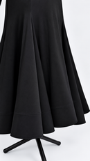 Flared black skirt hem close-up