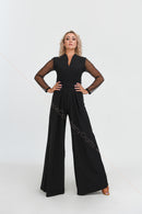 Black jumpsuit with polka dot mesh sleeves