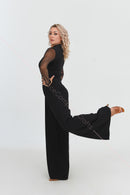 Black jumpsuit with polka dot mesh sleeves