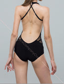 Black bodysuit with an open back with shoulder straps. Long fringe bodysuit